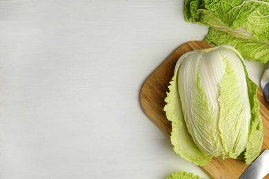 Photo of Fresh ripe Chinese cabbages on white wooden table, flat lay. Space for text