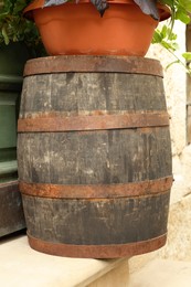 Photo of Traditional wooden barrel on street outdoors. Wine making