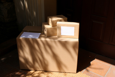 Photo of Delivered parcels on door mat near entrance