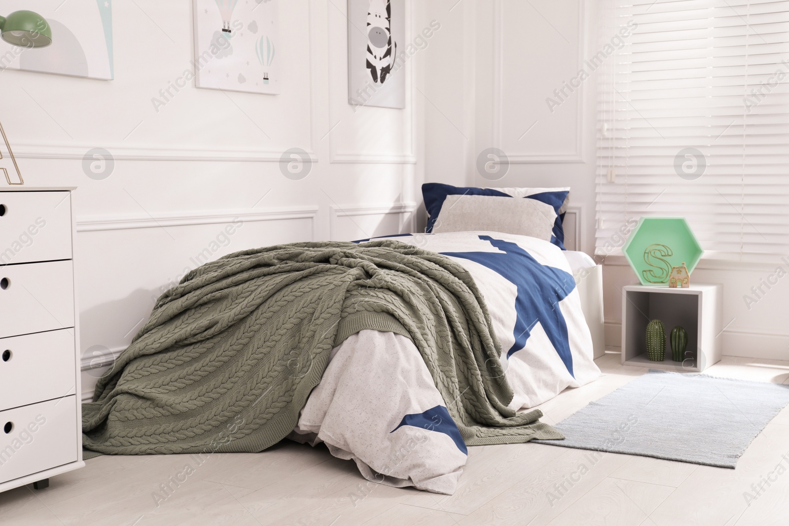 Photo of Bed with stylish linens in children's room