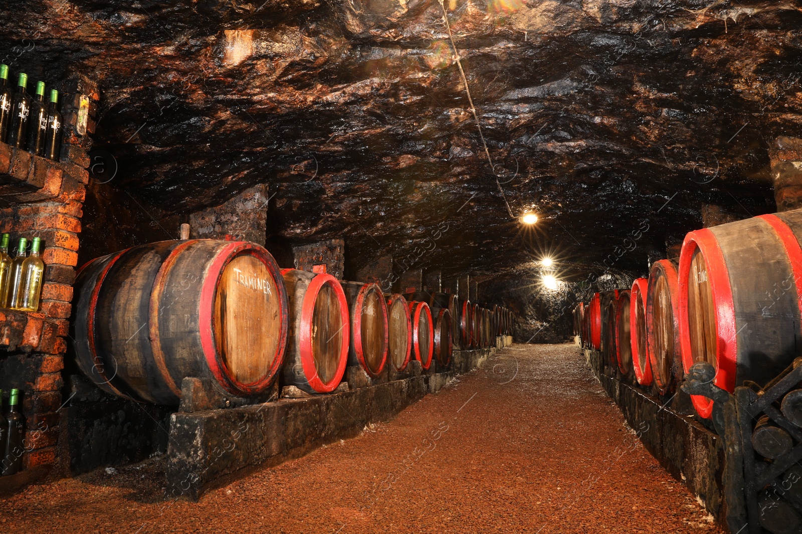 Photo of Bene, Ukraine - June 23, 2023: Many wooden barrels with alcohol drinks in cellar