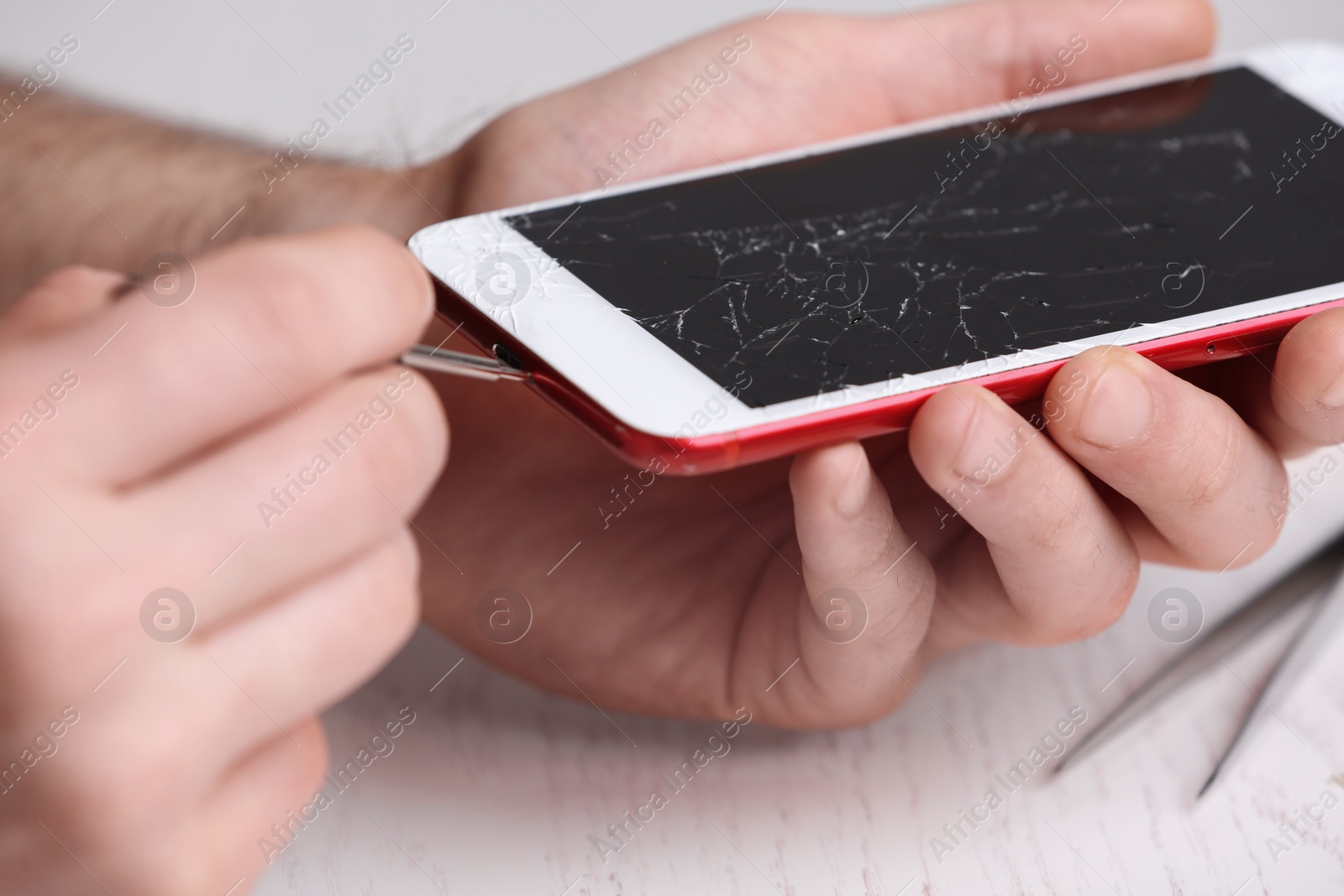 Photo of Technician fixing mobile phone at table, closeup. Device repair service