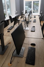Photo of Many modern computers in open space office, above view