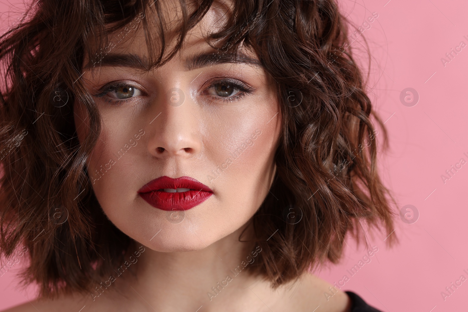 Photo of Beautiful young woman with wavy hairstyle on pink background