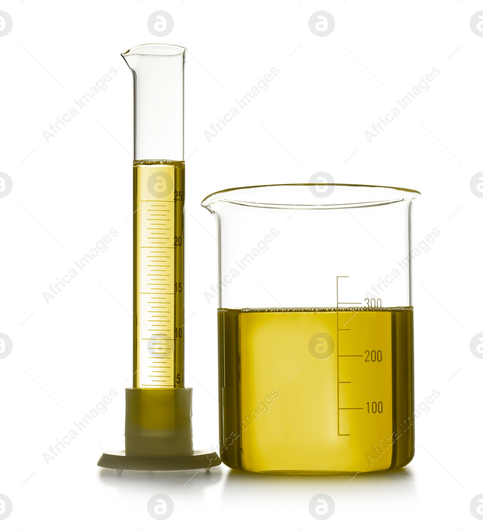 Image of Beaker and graduated cylinder with yellow liquid isolated on white. Laboratory glassware