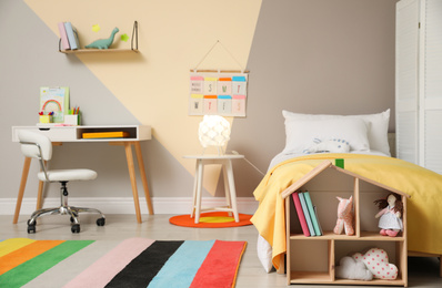 Photo of Stylish child room interior with comfortable bed and  toys