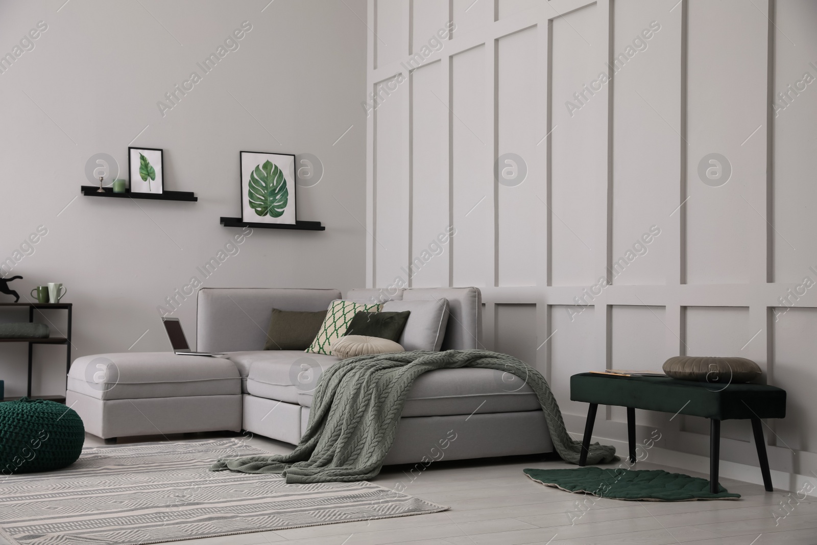 Photo of Living room with comfortable grey sofa and stylish interior elements