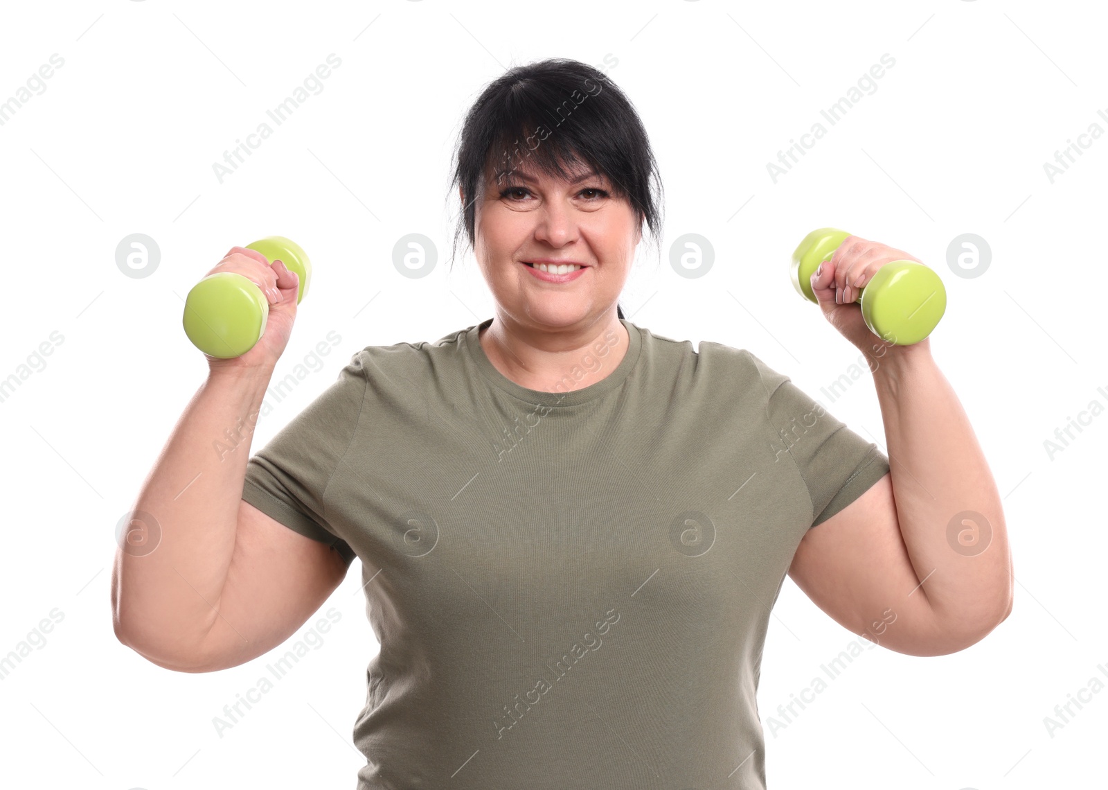 Photo of Happy overweight mature woman doing exercise with dumbbells on white background