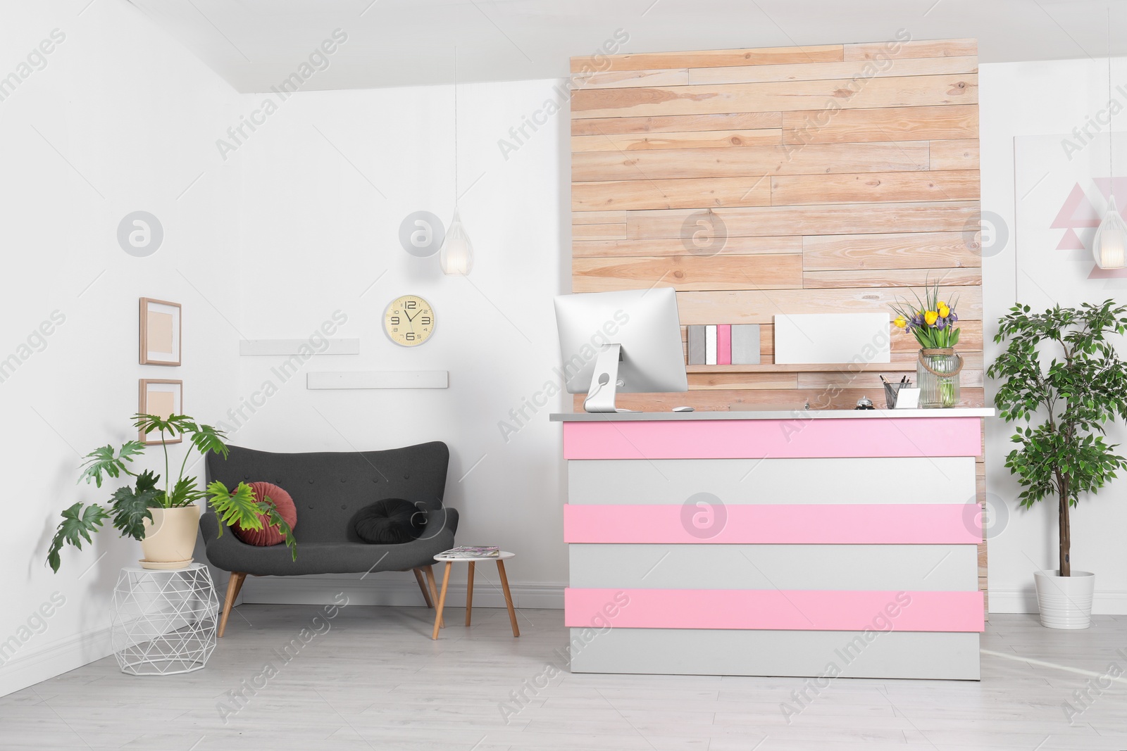 Photo of Stylish interior of beauty salon with modern reception desk near wooden wall