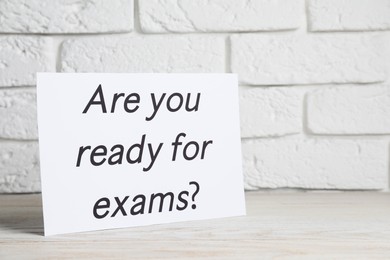 Paper with question Are you ready for exams on white wooden table
