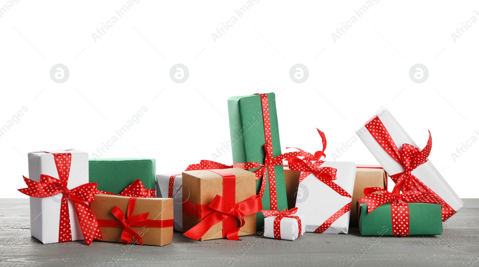 Photo of Many different Christmas gifts on grey wooden table against white background