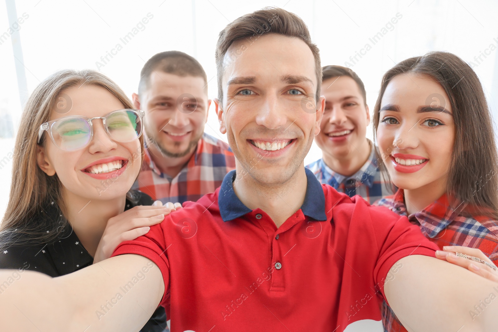 Photo of Happy friends taking selfie indoors