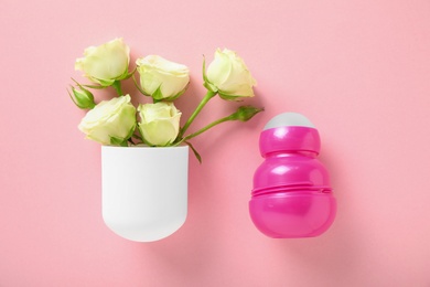 Photo of Flat lay composition with natural female roll-on deodorant on pink background