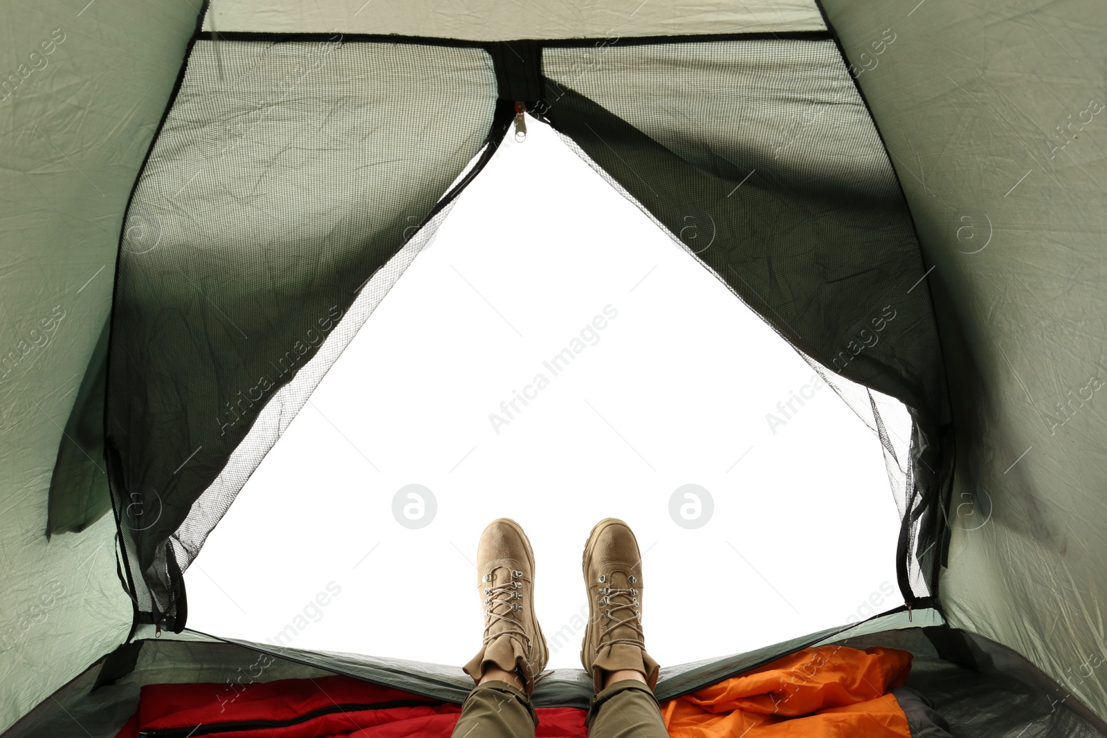 Photo of Closeup of female in camping tent on white background, view from inside