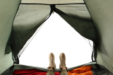 Closeup of female in camping tent on white background, view from inside