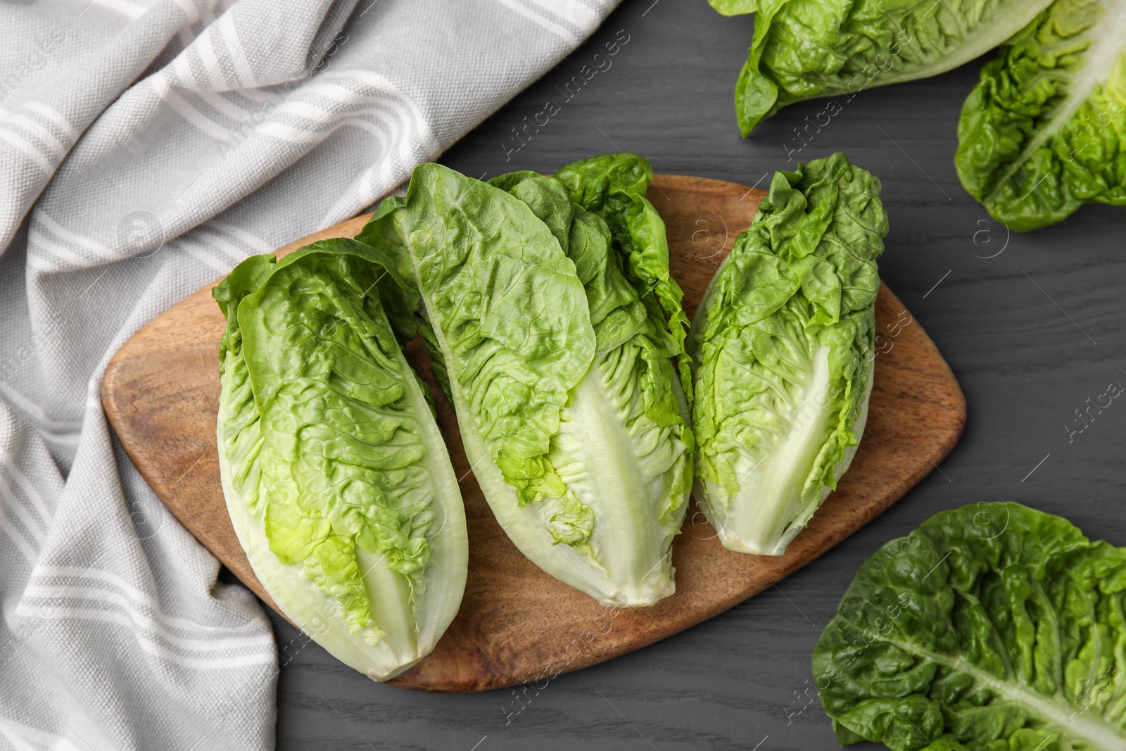 Photo of Fresh green romaine lettuces on grey wooden table, flat lay