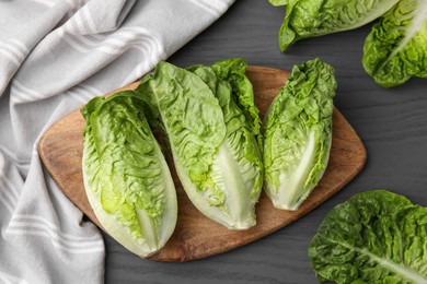 Photo of Fresh green romaine lettuces on grey wooden table, flat lay
