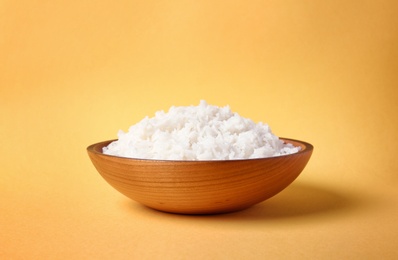 Photo of Bowl of boiled rice on color background