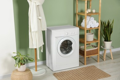 Stylish laundry room with washing machine. Interior design