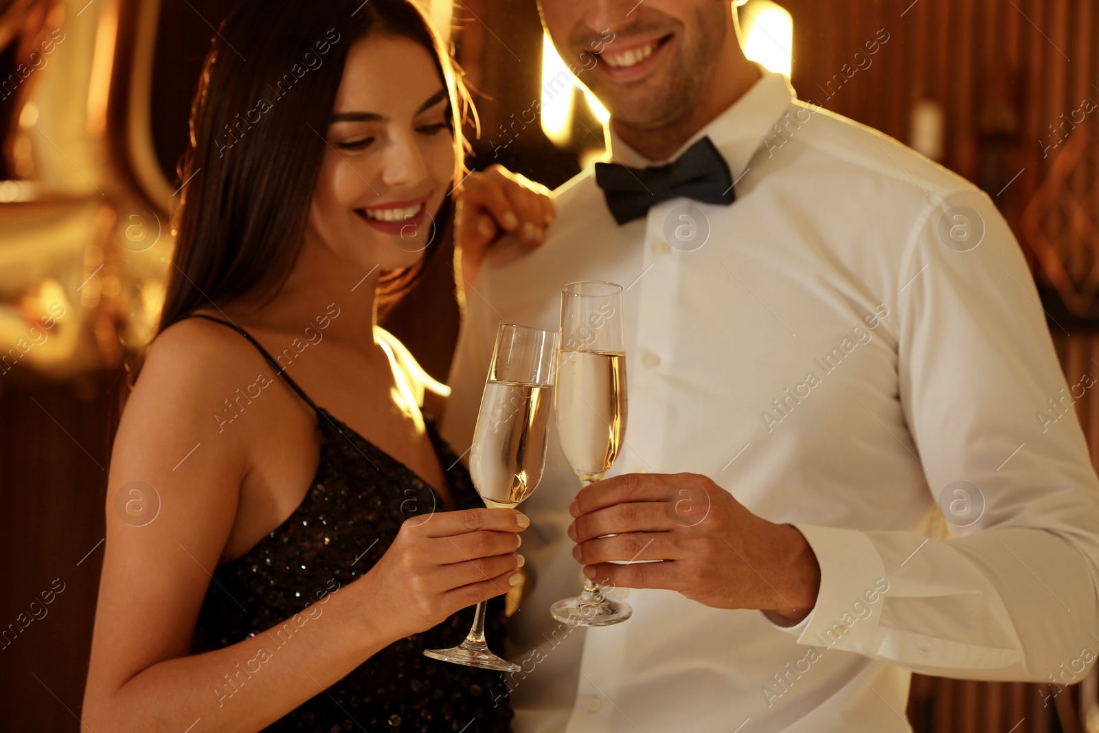 Photo of Young couple celebrating New Year in club, closeup