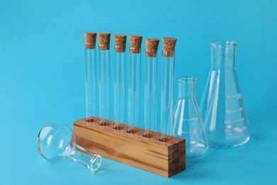 Photo of Different laboratory glassware on light blue background