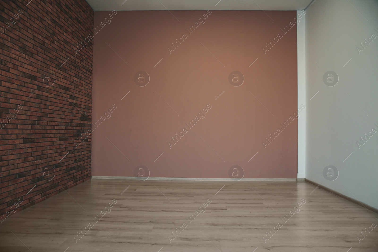 Photo of Empty room with different walls, white door and wooden floor