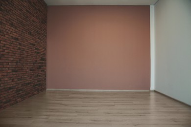 Photo of Empty room with different walls, white door and wooden floor