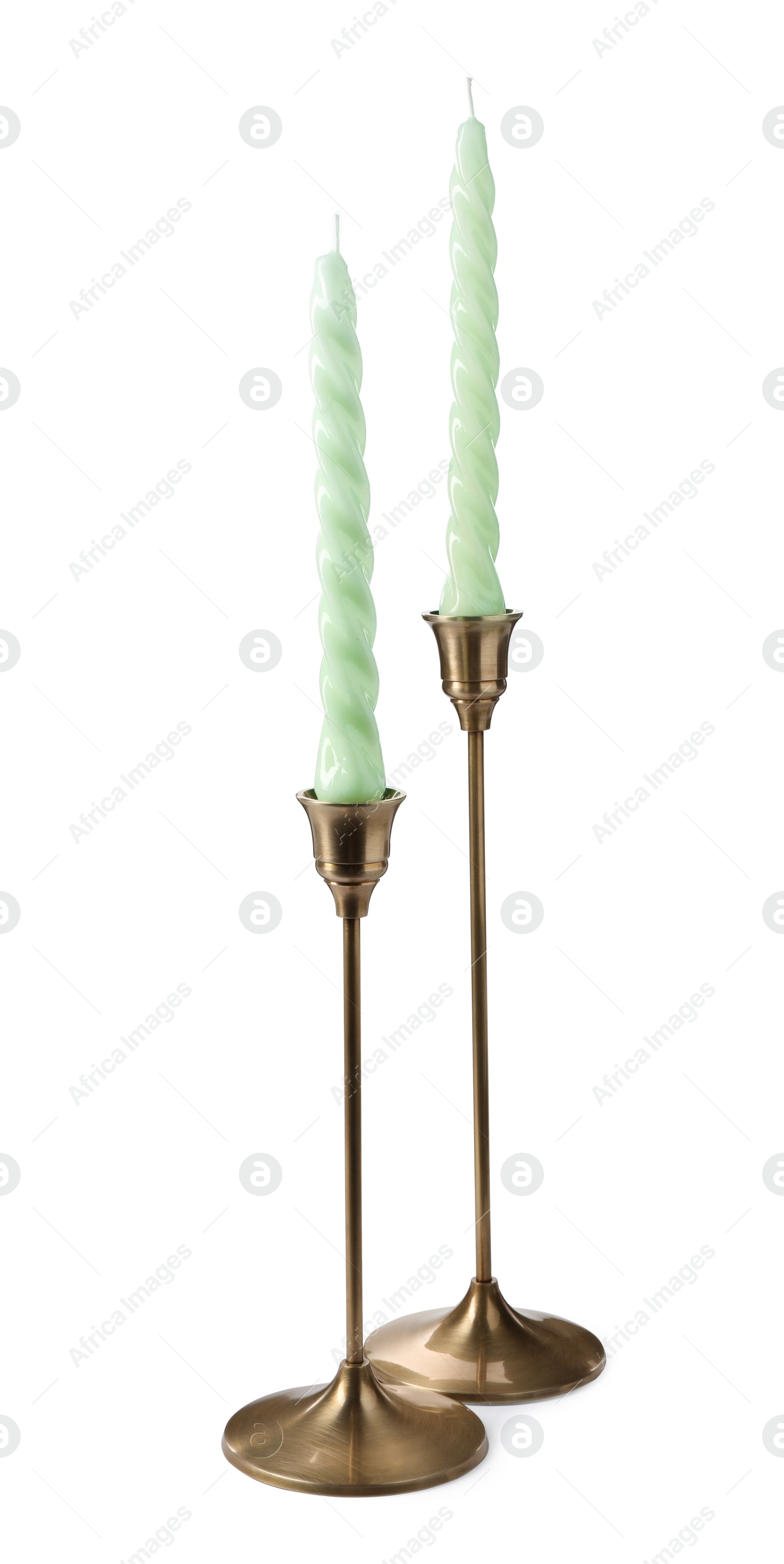 Photo of Vintage metal candlesticks with candles on white background