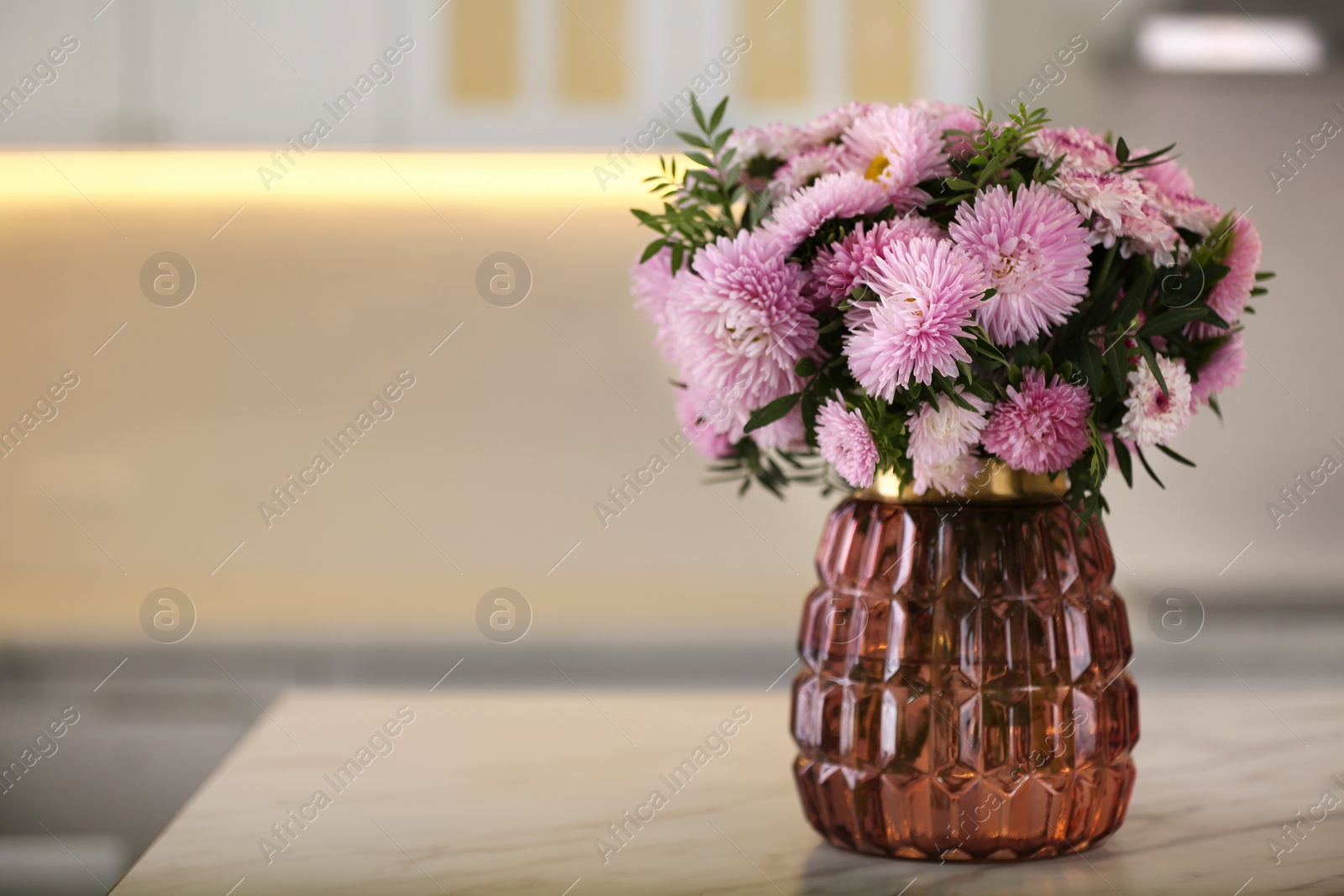 Photo of Vase with beautiful chrysanthemum flowers on table in kitchen, space for text. Interior design