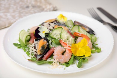Photo of Platedelicious salad with seafood on white table