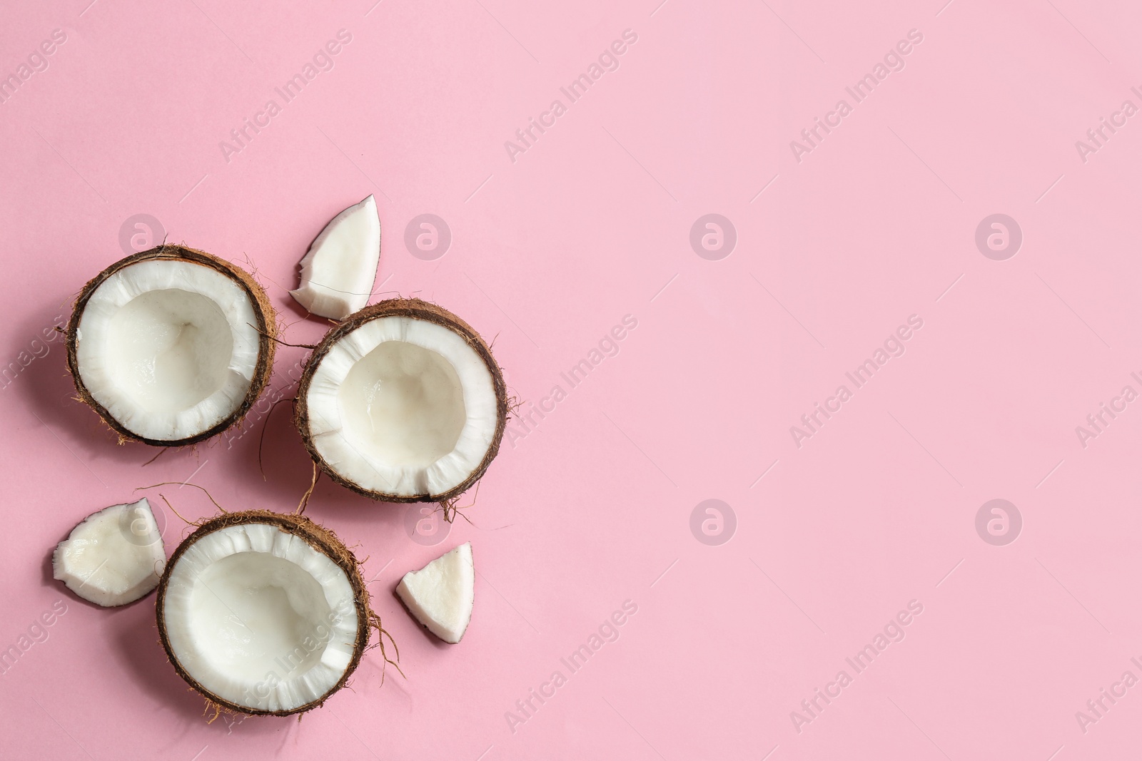 Photo of Flat lay composition with coconuts on color background. Space for text