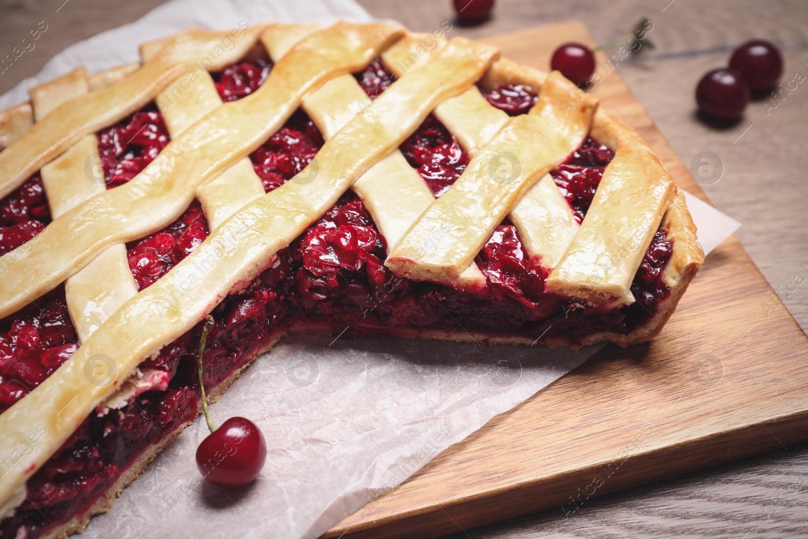 Photo of Delicious fresh cherry pie on wooden board, closeup