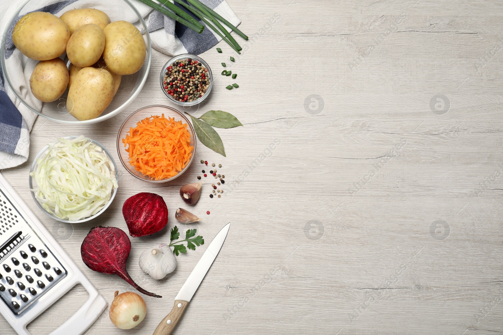 Photo of Fresh borscht ingredients on white wooden table, flat lay. Space for text