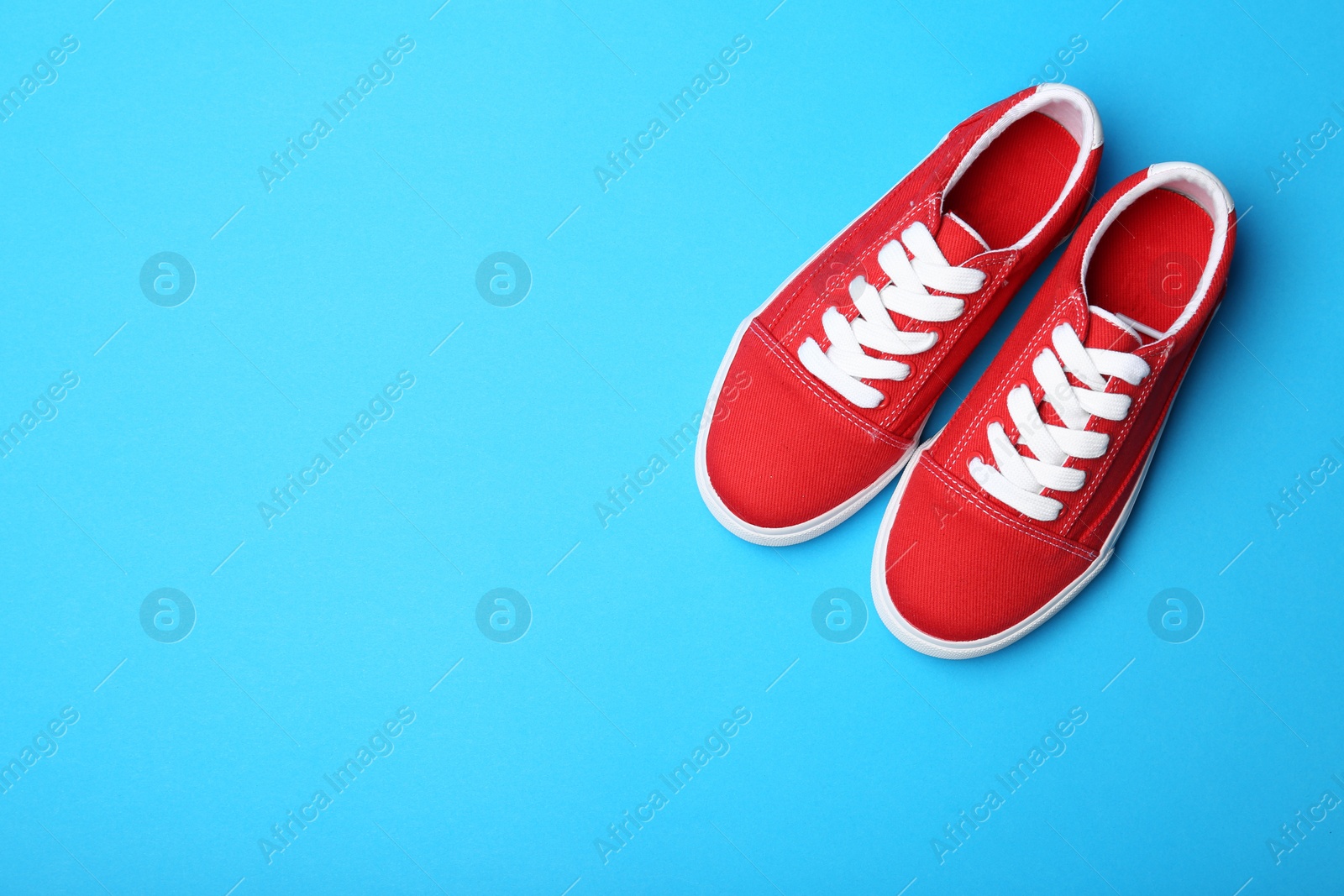 Photo of Stylish new shoes on color background, top view