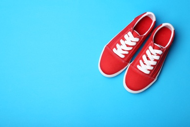 Photo of Stylish new shoes on color background, top view