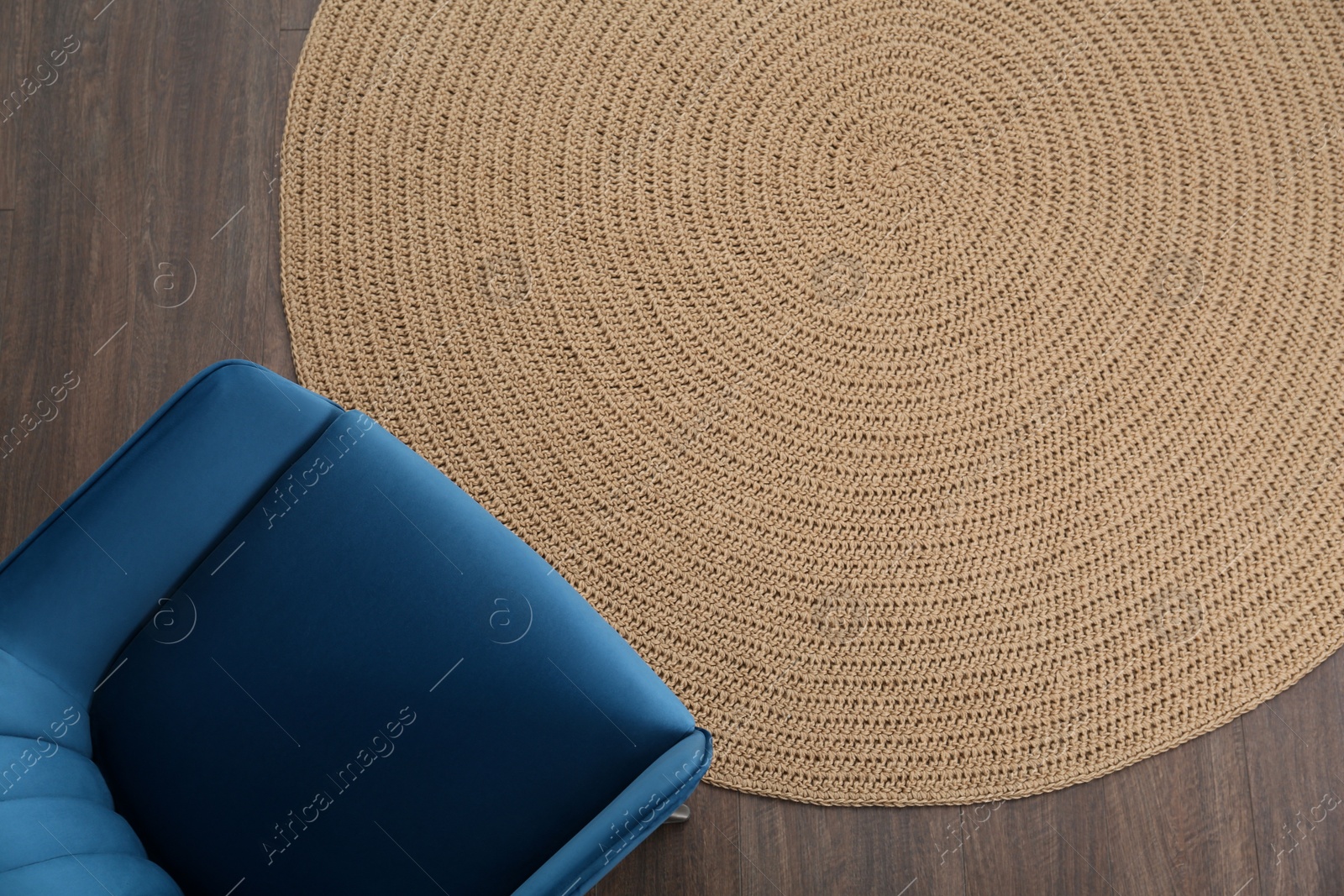 Photo of Stylish blue armchair on floor, top view. Space for text