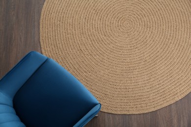 Photo of Stylish blue armchair on floor, top view. Space for text