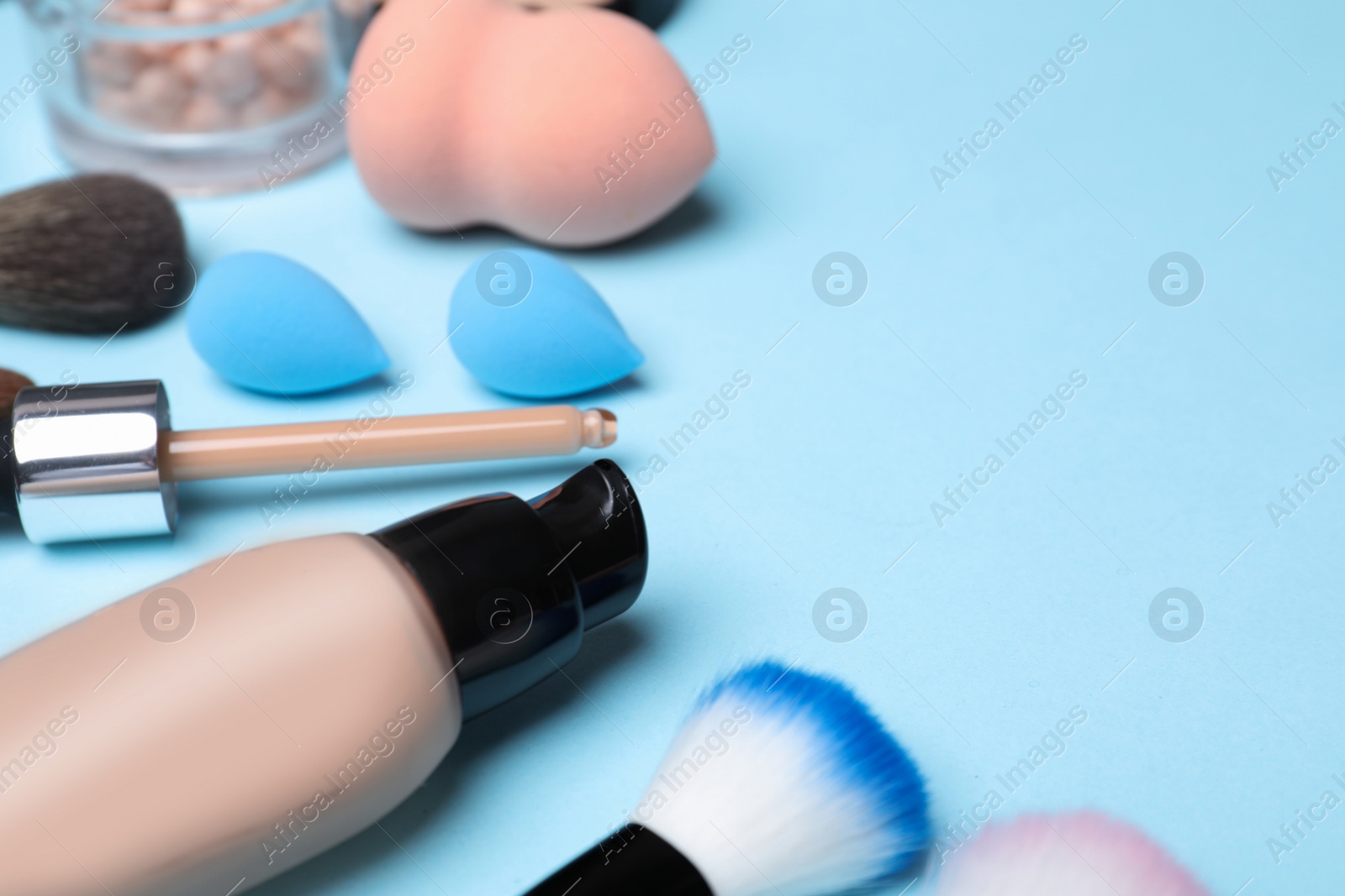 Photo of Composition with skin foundation and beauty accessories on color background. Space for text