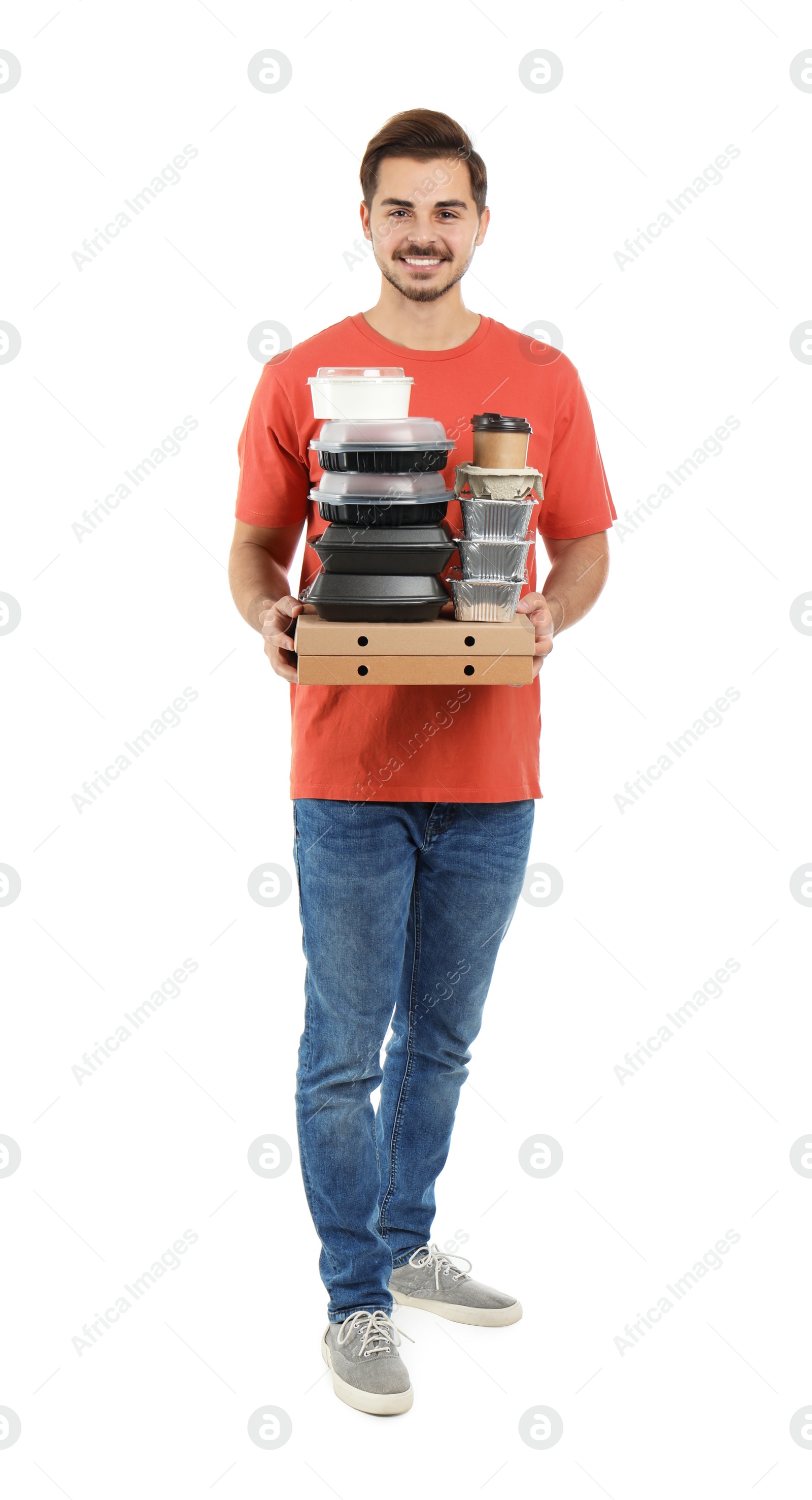 Photo of Young courier with pizza boxes, containers and drinks on white background. Food delivery service