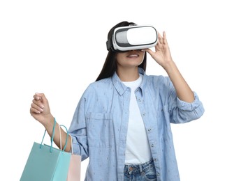 Photo of Woman with shopping bags using virtual reality headset on white background