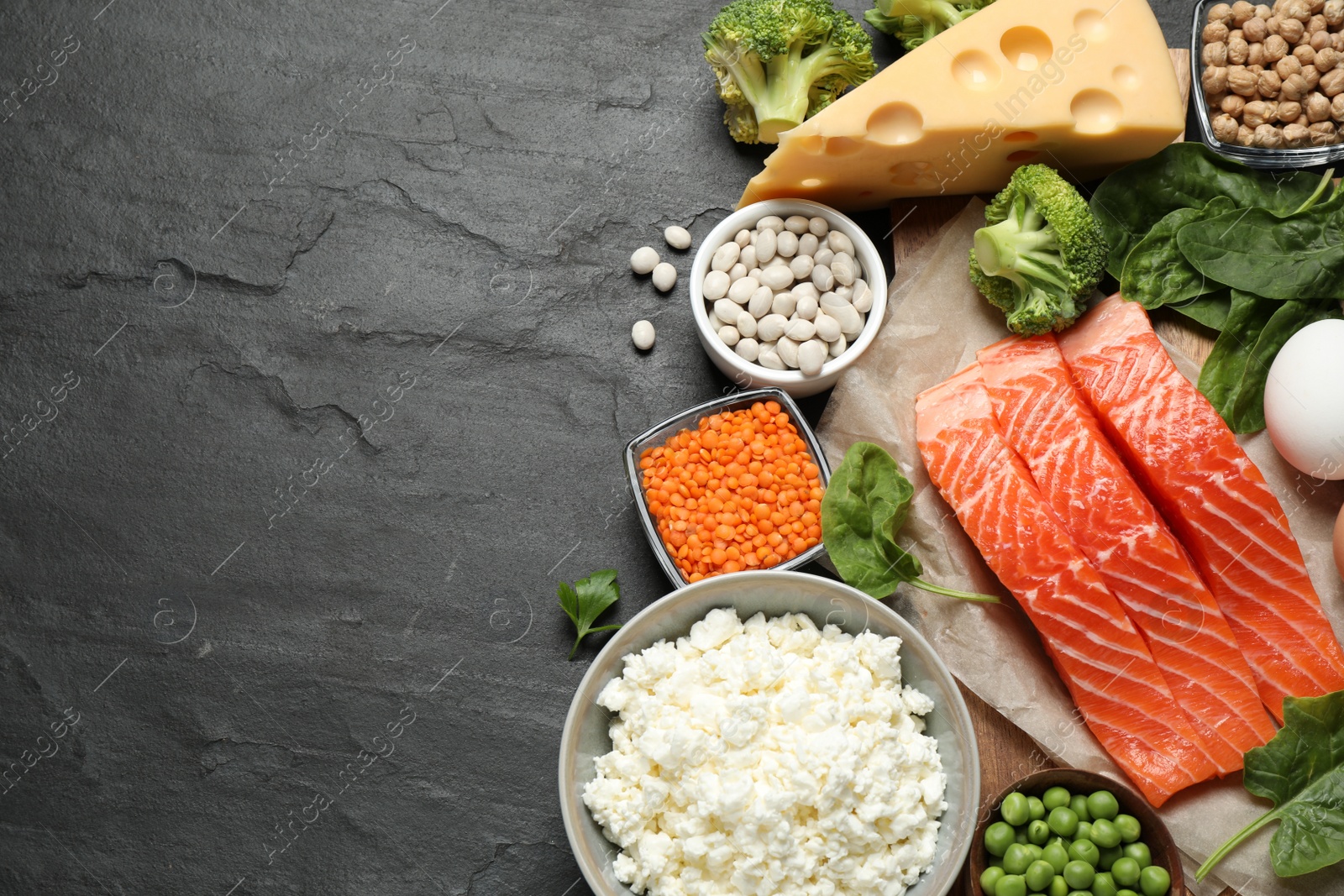 Photo of Products rich in protein on black table, flat lay. Space for text