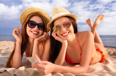 Photo of Young couple in bikini spending time together on beach