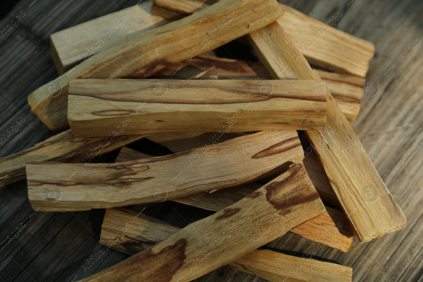 Photo of Palo santo sticks on wooden table, top view