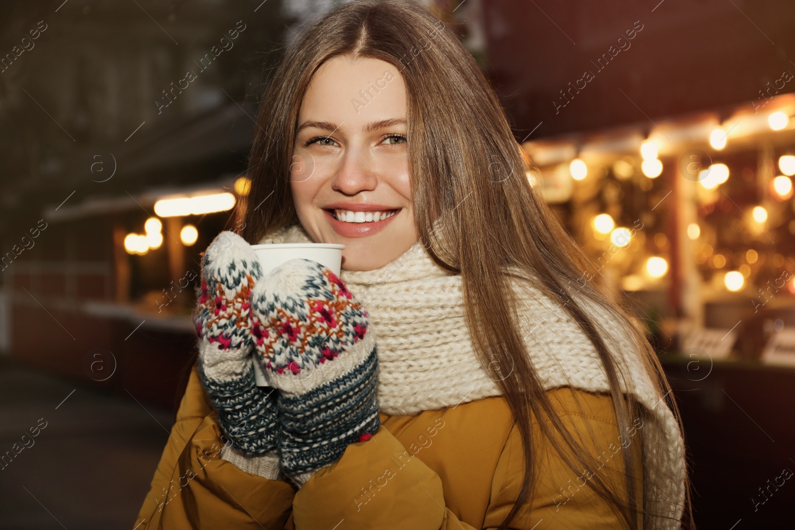 Photo of Happy woman with mulled wine at winter fair