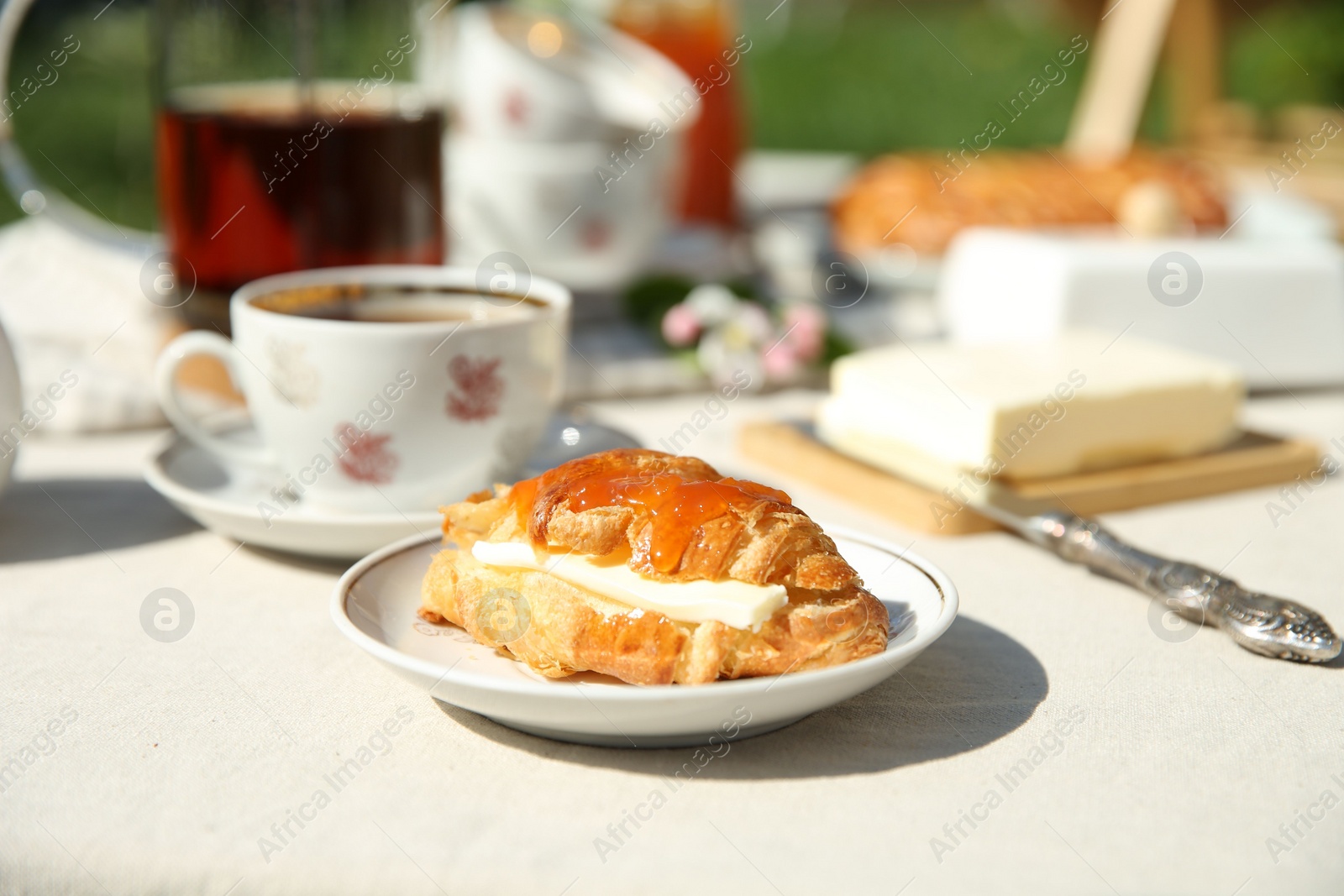 Photo of Beautiful table setting in garden on sunny day, closeup