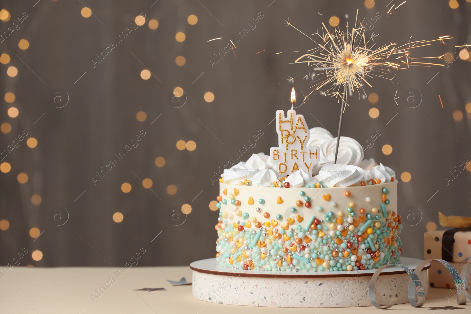 Photo of Beautiful birthday cake with festive decor on white table. Space for text