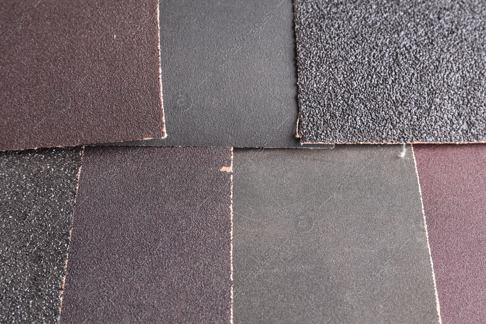 Photo of Many sheets of sandpaper as background, top view