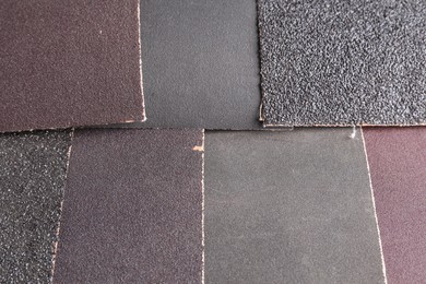 Many sheets of sandpaper as background, top view