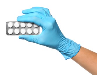 Scientist in protective gloves holding pills on white background, closeup