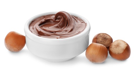 Photo of Bowl of chocolate paste with hazelnuts on white background